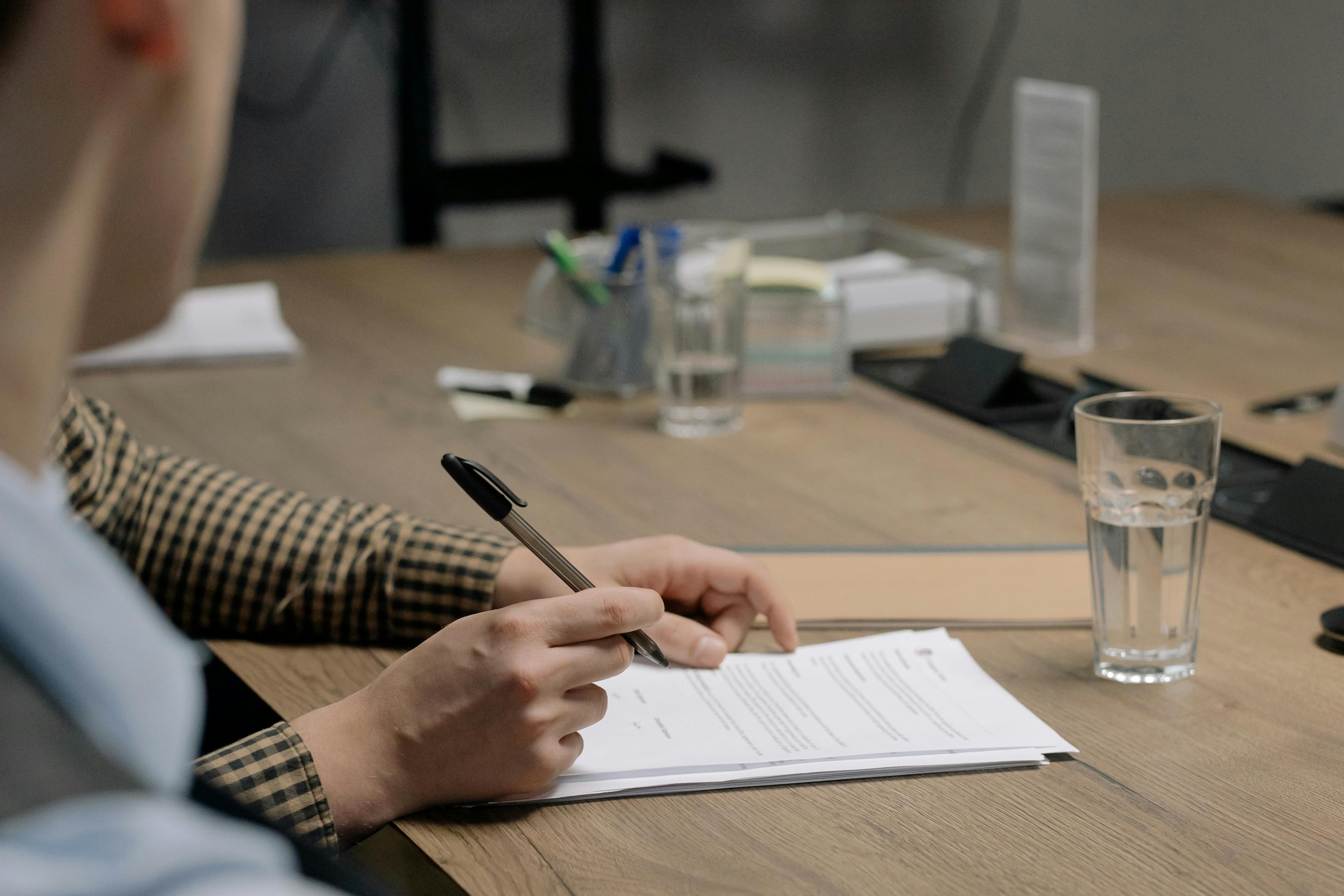 Signing documents that are on a table