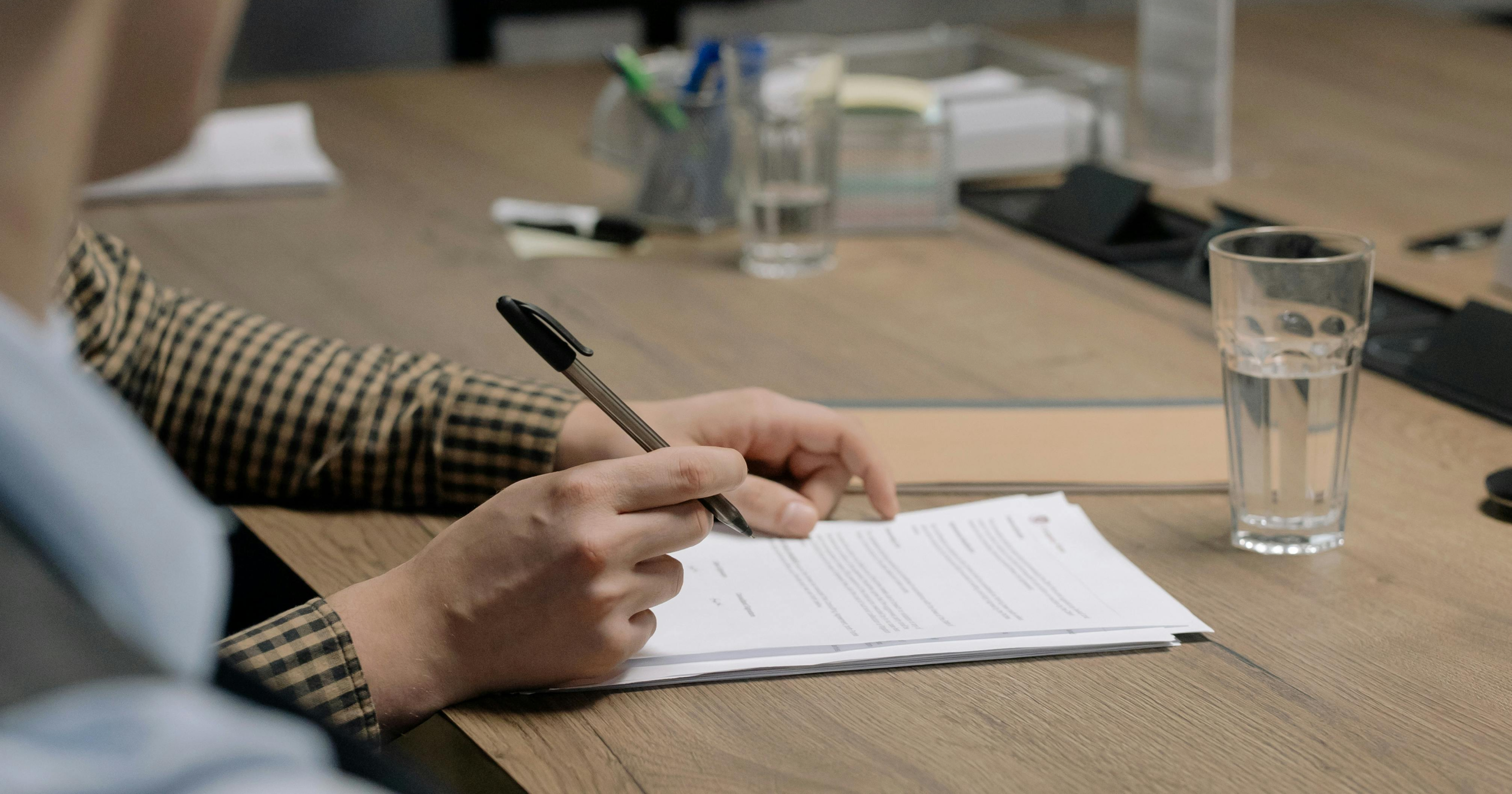 Signing documents that are on a table